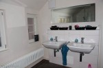 Two sinks with mirror across from shower