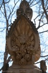 Odd lion with flowers a decoration on park wall