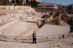 Friendly Tourist in front of the medieval churches inside the Roman arena