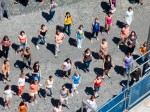 Dancers forming a circle around the first woman