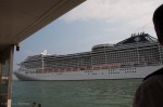 Front of the MSC Divinia as it passes by a (boat)bus stop