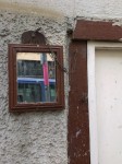 Mirror and Comb, on the wall on a street in Tübingen