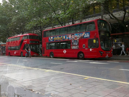 Two models of the red double-decker buses, seen in London in September 2014