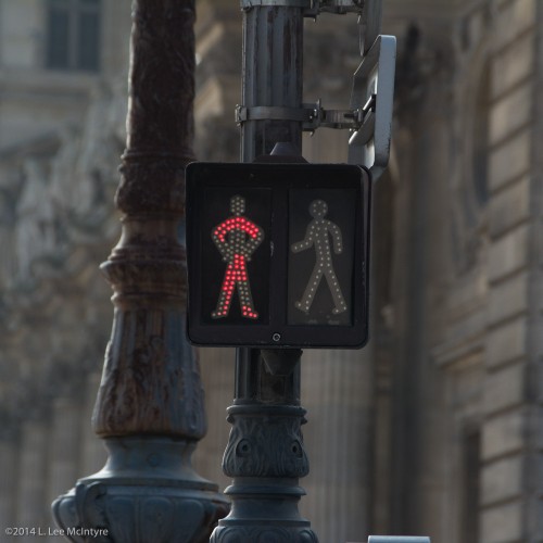 Crossing figure for "Stop" near the Louvre, Paris